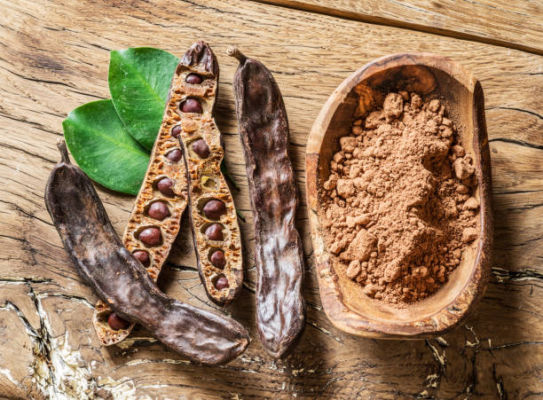 Carob pods and carob beans on the wooden table. Menopause cookies